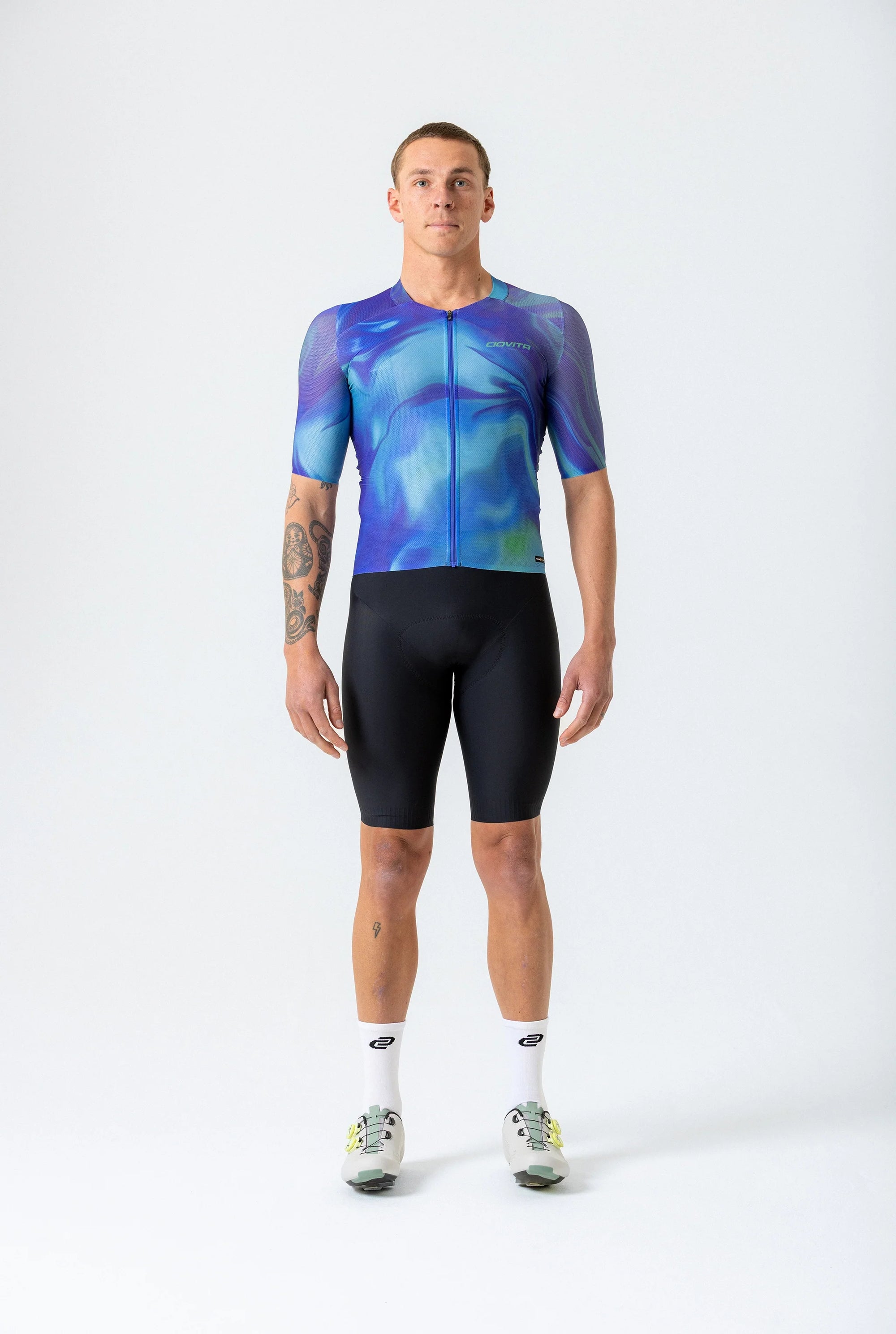 Person wearing a blue and black cycling outfit on a white background