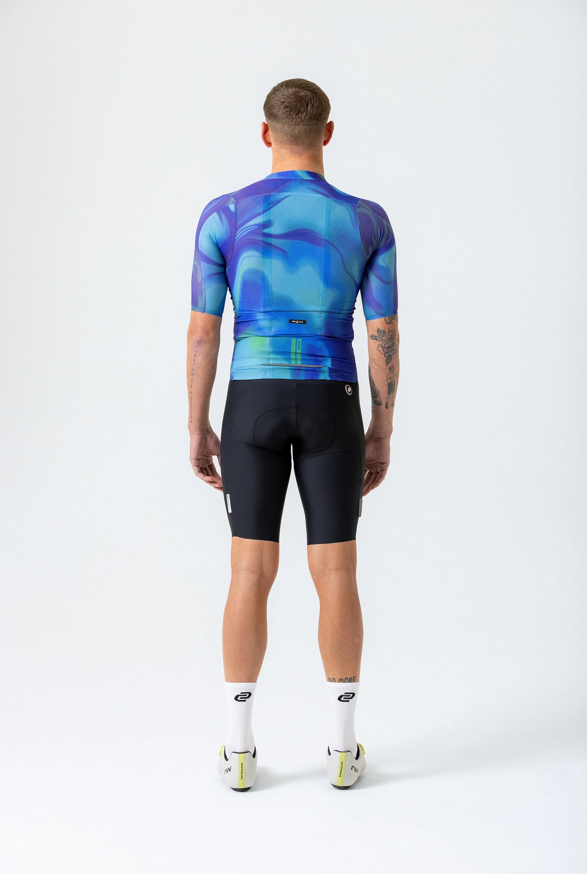 Person wearing a blue and purple cycling outfit on a white background