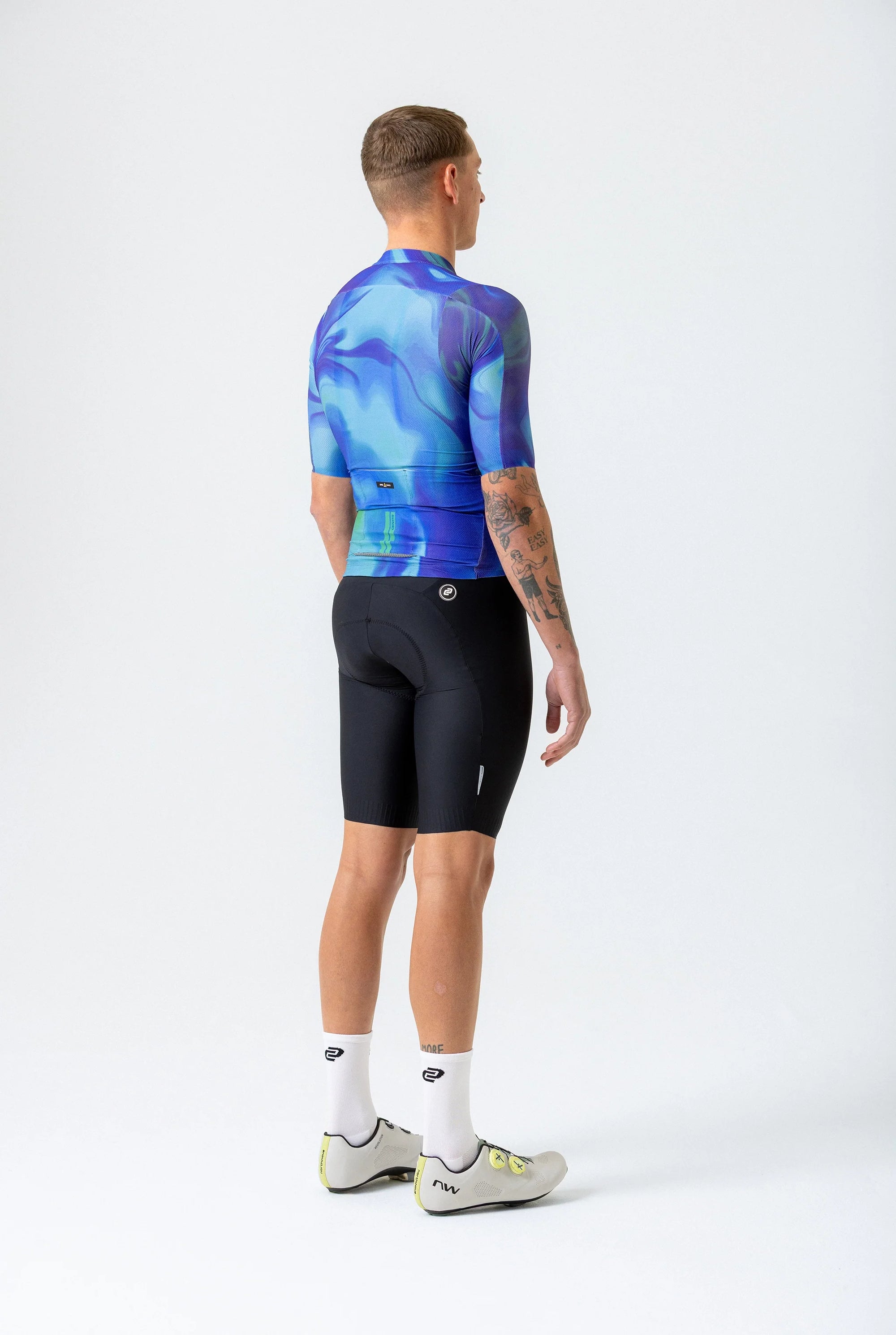 Person wearing a blue and black cycling outfit on a white background