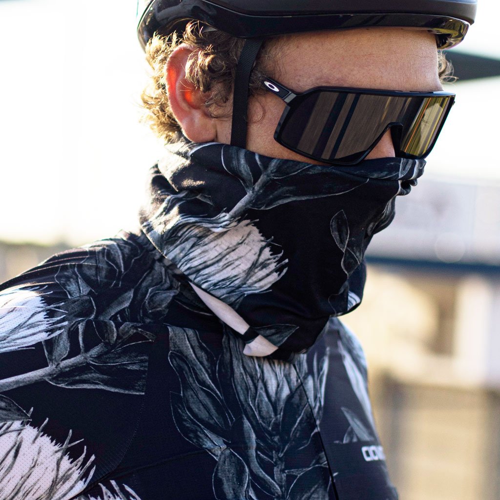 cyclist wearing headscarf with black and white protea print
